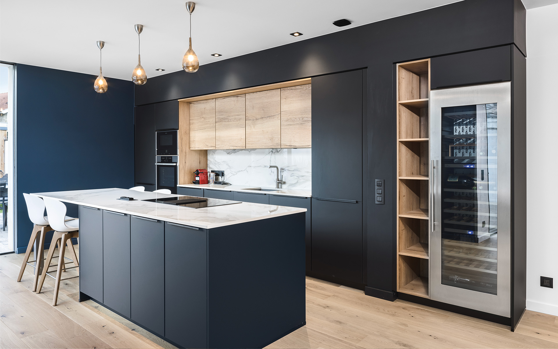 une cuisine moderne en marbre et noire ouverte sur le séjour